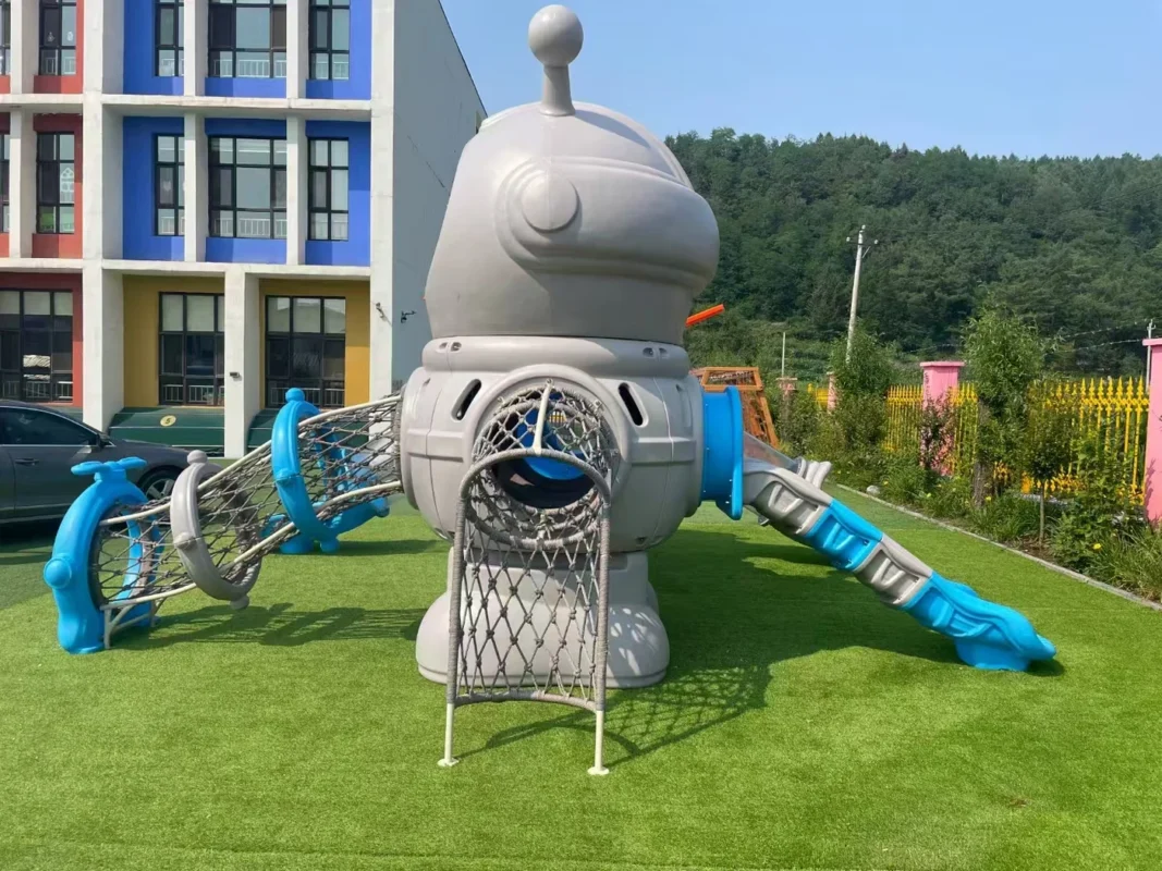 Playground Equipment Manufacturer | Indoor Soft Play & Custom Outdoor Playgrounds | Xinjiu Distinctive astronaut-themed outdoor play structure with blue slides and a rope tunnel