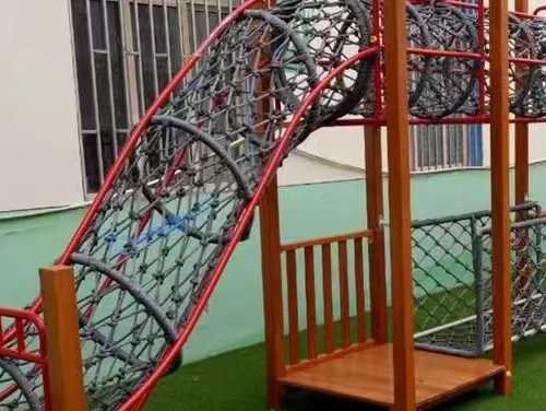 Playground Equipment Manufacturer | Indoor Soft Play & Custom Outdoor Playgrounds | Xinjiu Close-up of an arched rope climbing net attached to timber supports