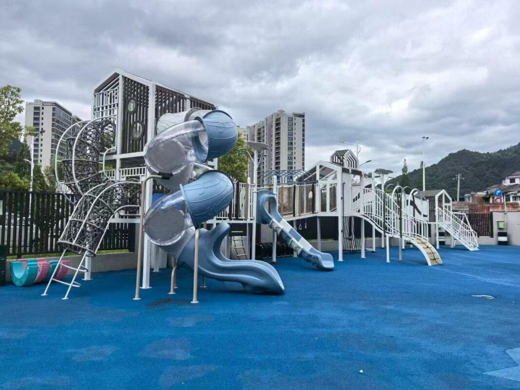Indoor & Outdoor Playground Equipment | Soft Play, Custom Structures & Slides | Xinjiu Architectural playground with tall spiral tube slides