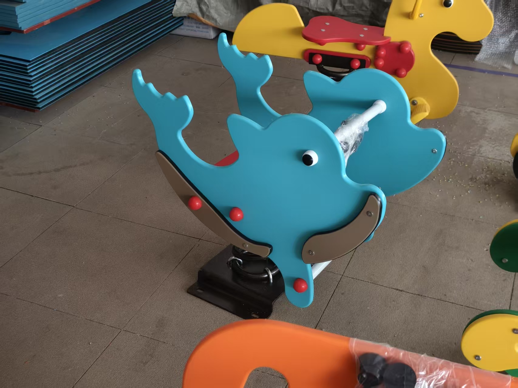 Spring Rider Manufacturer: Molded Plastic or PE Panel for Your Project? Blue dolphin PE panel spring rider with graphic silhouette