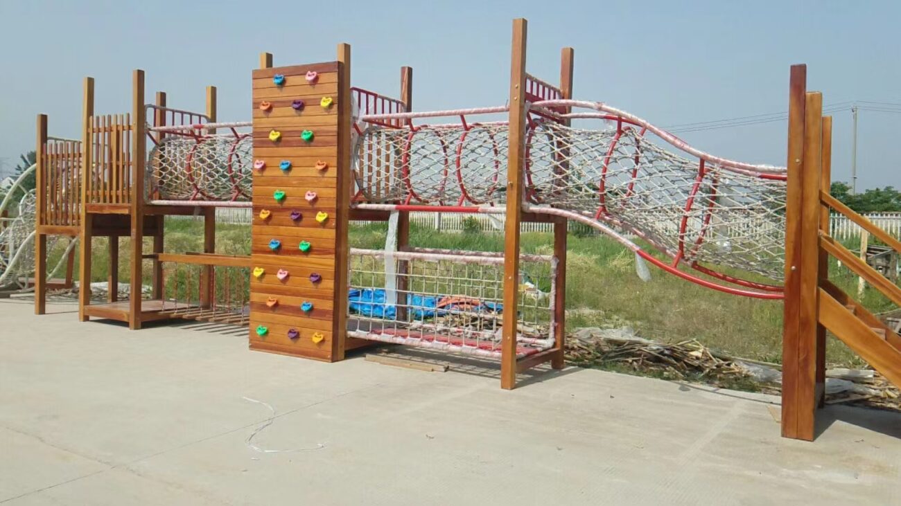 Indoor & Outdoor Playground Equipment | Soft Play, Custom Structures & Slides | Xinjiu Wooden playground climbing net course with bridge