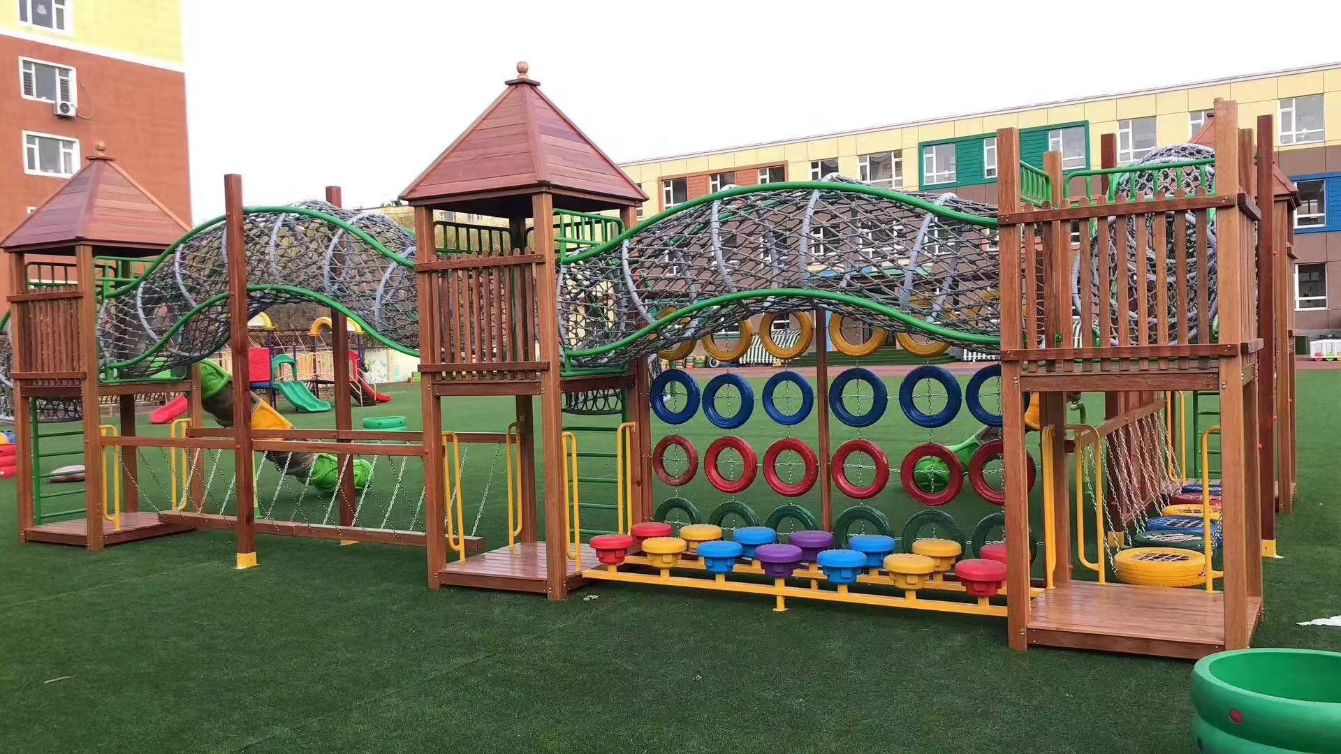 Timber rope bridge playset for a landscaped school playground